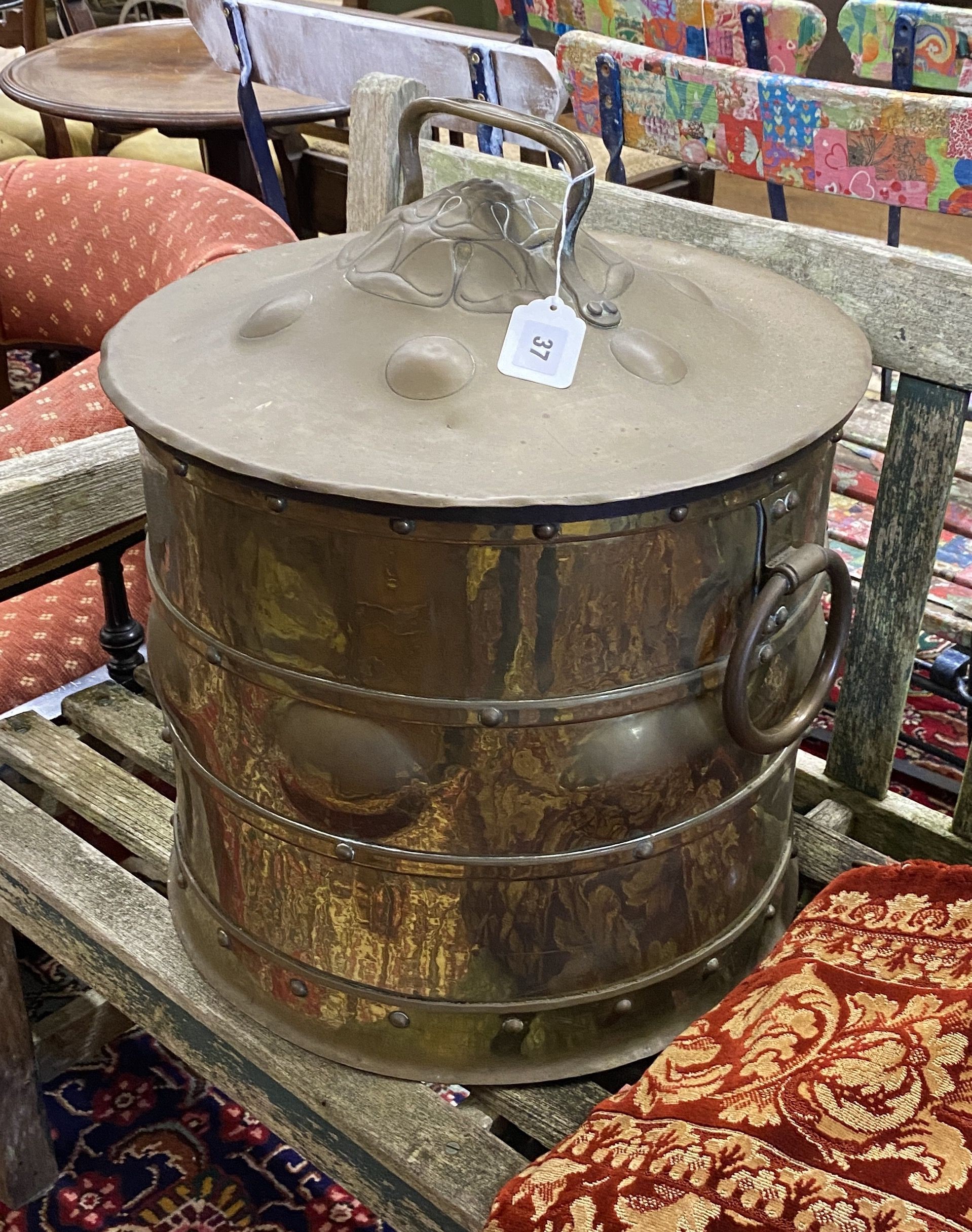 An Arts & Crafts circular embossed brass coal bin, diameter 42cm, height 46cm